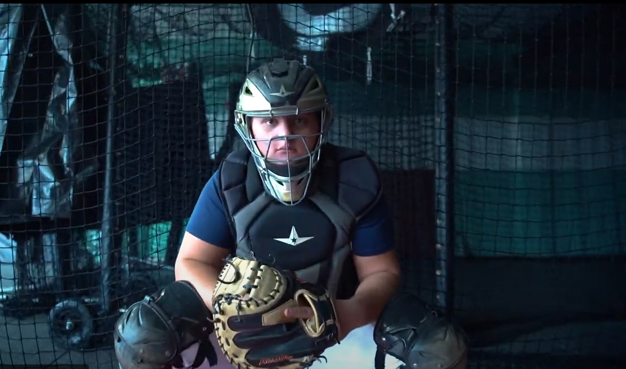 A baseball player in a catcher's mitt.