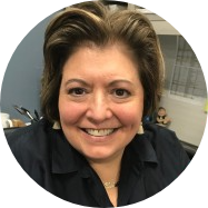 An image of a woman smiling in an office.