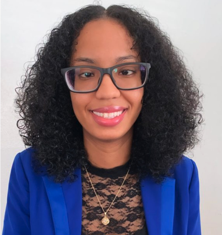 Michell Marin, a young woman, wearing glasses and a blue blazer.